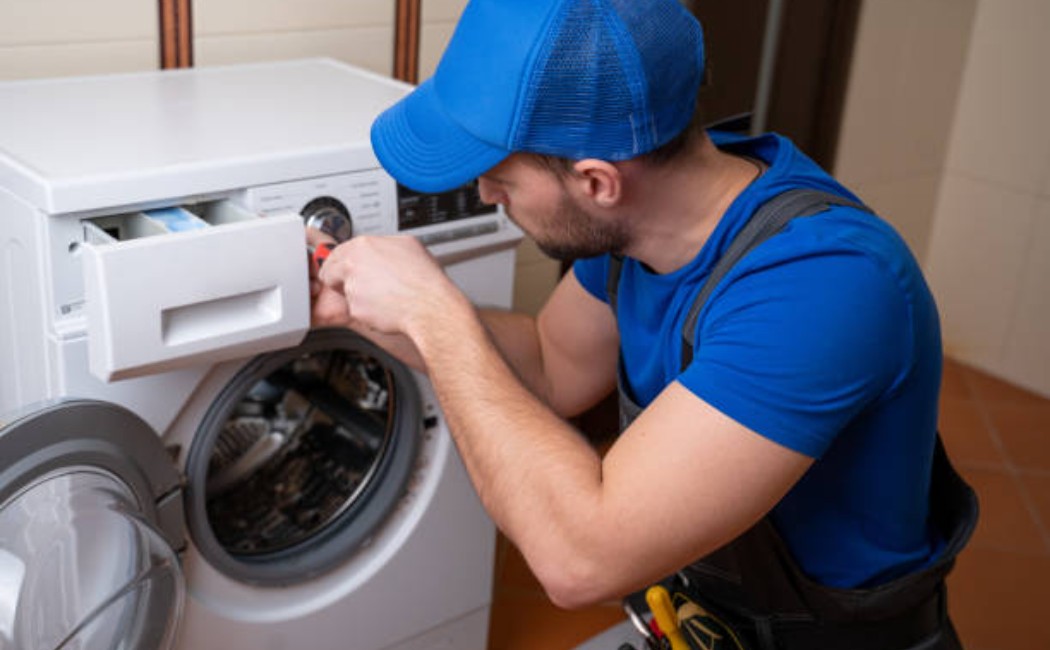 Home appliance installation services technician checking the washer