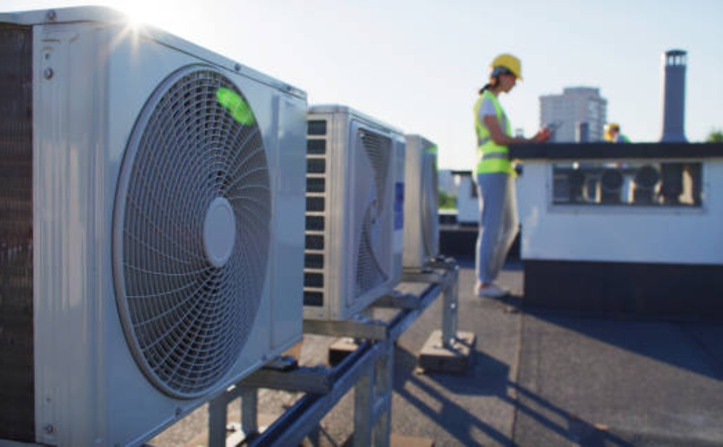 Industrial maintenance worker reviewing controls with a clipboard in hand