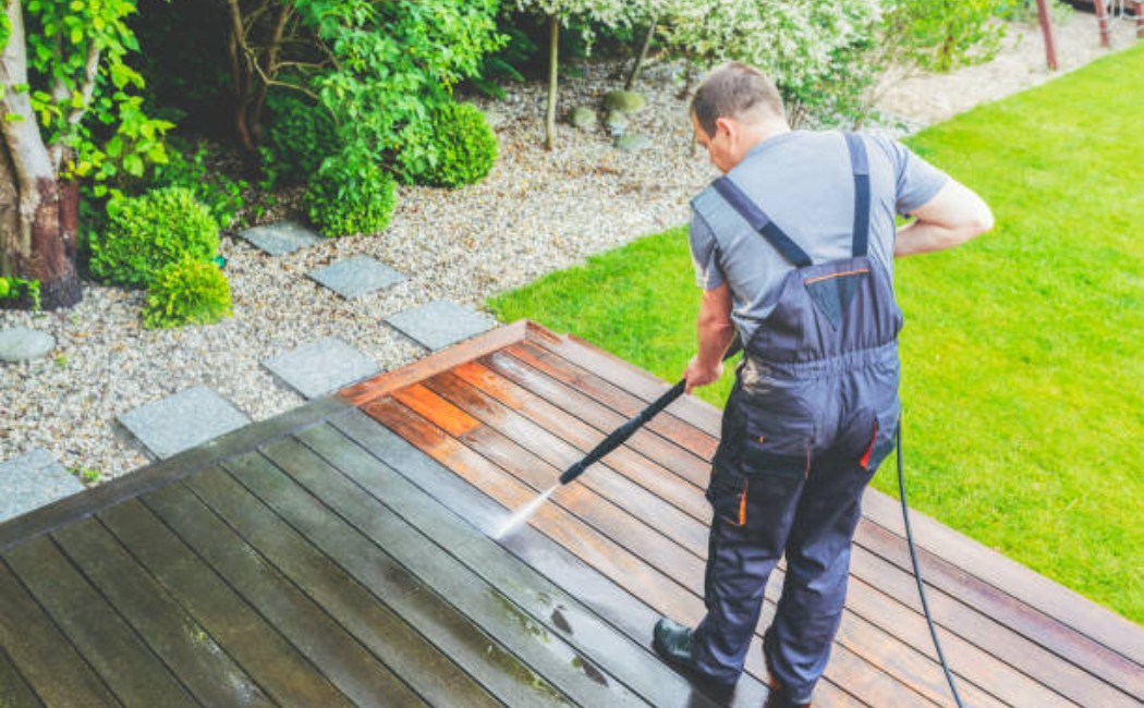 Clean sections of the wooden deck after power washing.