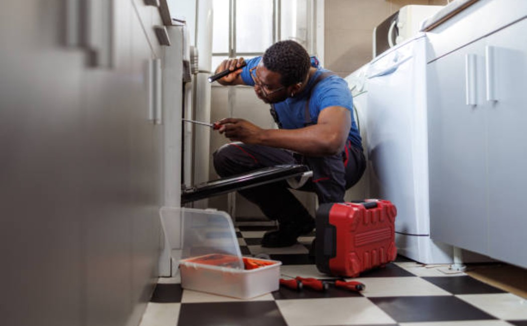 istockphoto-2154268610-612x612_1050x650_q90 Handyman installing stove components.