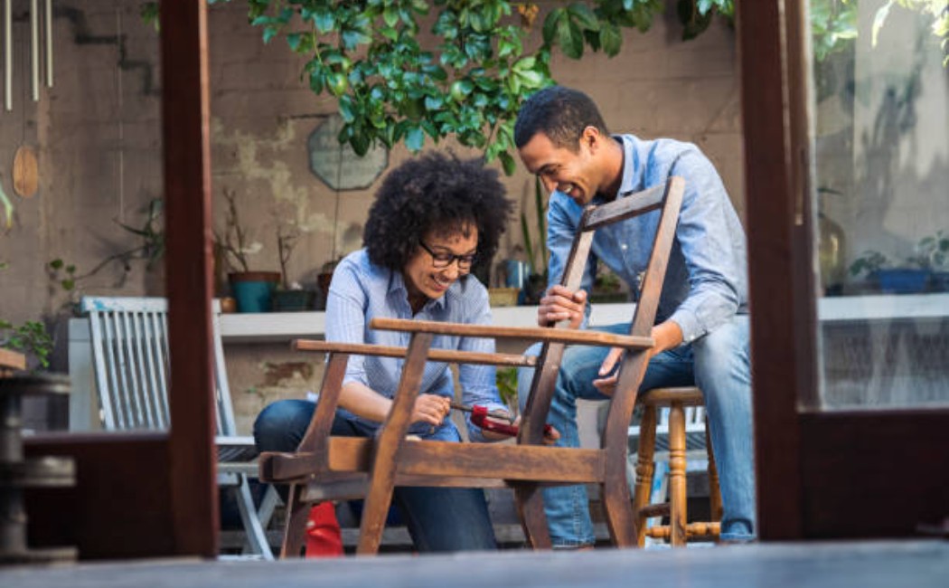 A couple doing furniture repair and restoration together