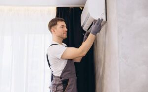 handyman installing a modern air conditioner unit