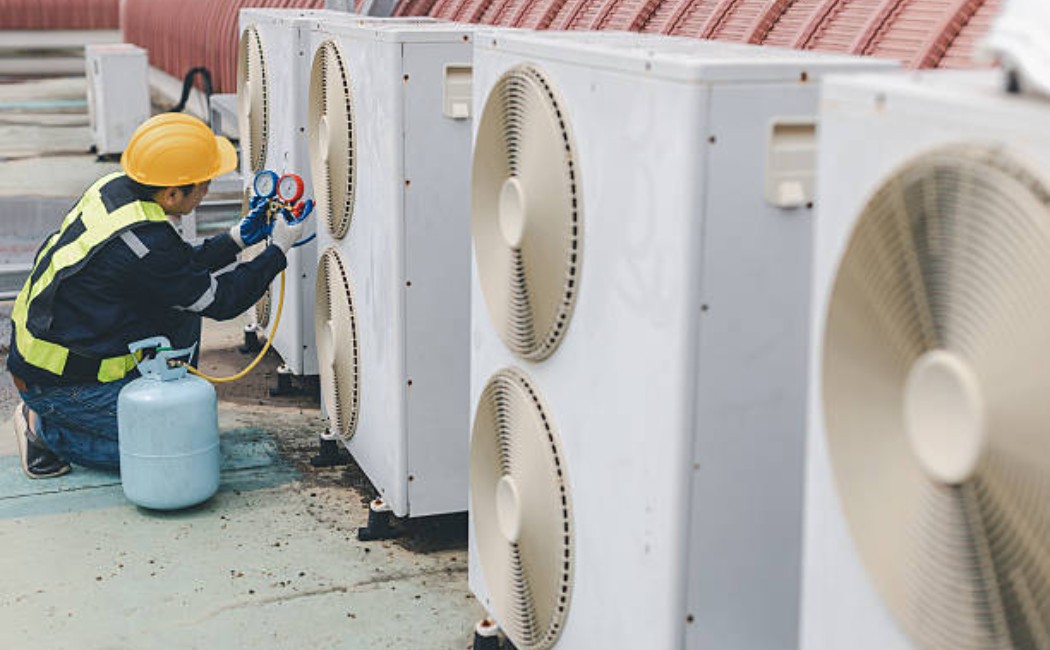 AC repair tools and gauges in the technician's hand